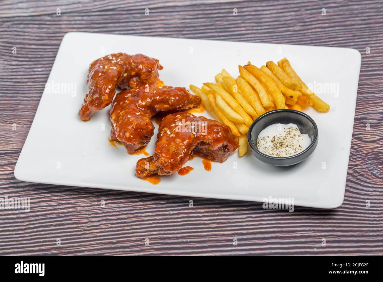 Symptomer Mand Bedstefar Hot and spicy buffalo chicken wings and crispy french fries with white  sauce Stock Photo - Alamy