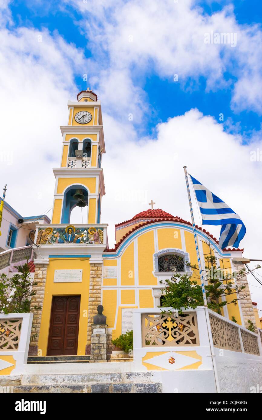 Church of Assumption of Virgin Mary with Greek Flag, Olympos, Karpathos, Dodecanese Island, Greece Stock Photo