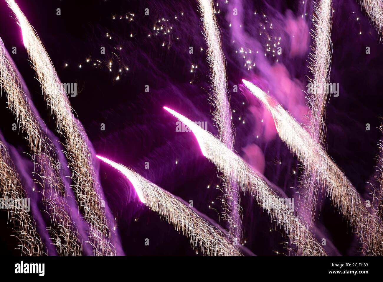 Light trails from the fireworks on a dark background. Stock Photo