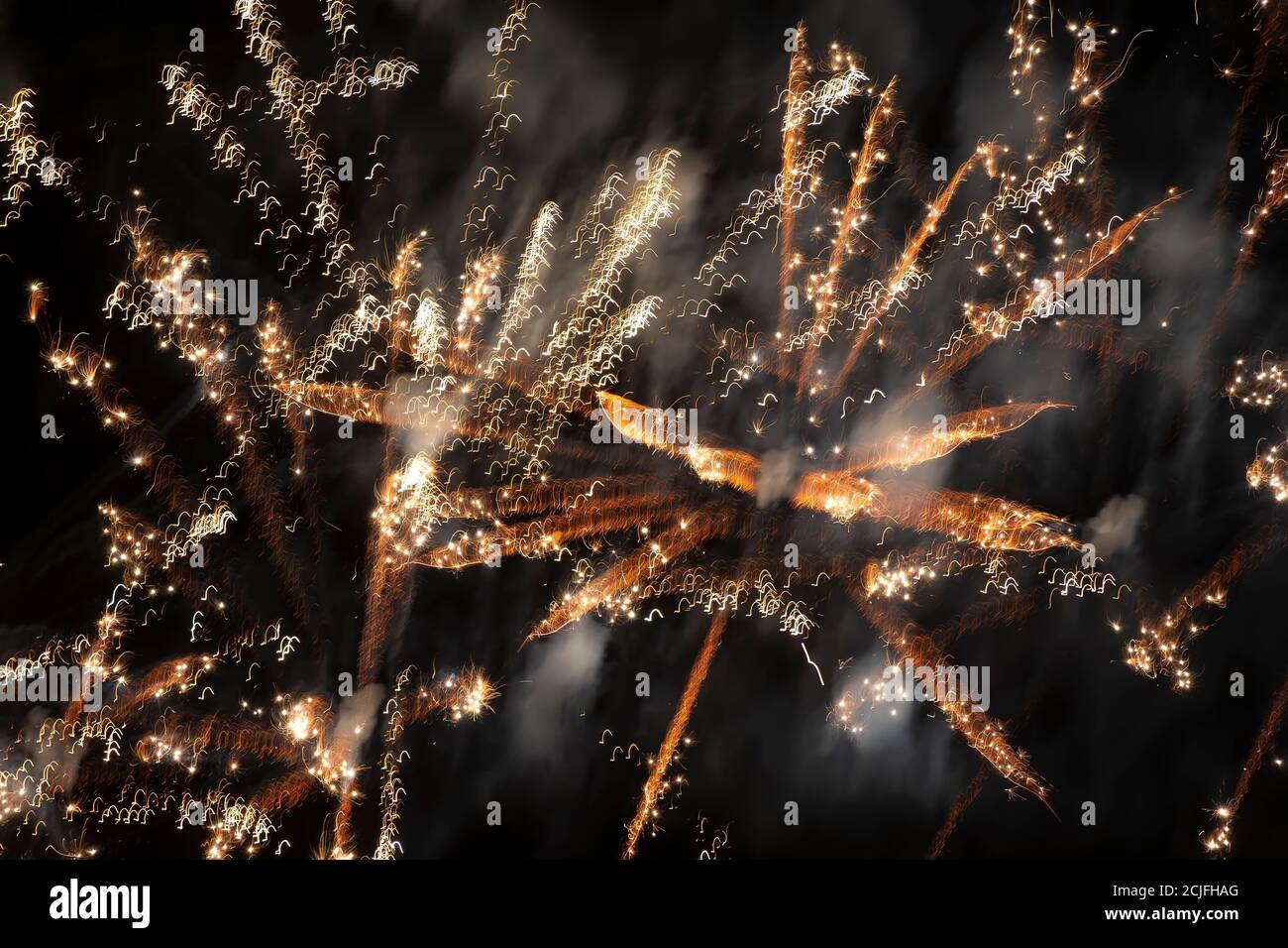 Blurred golden fireworks lights on a black background. Stock Photo