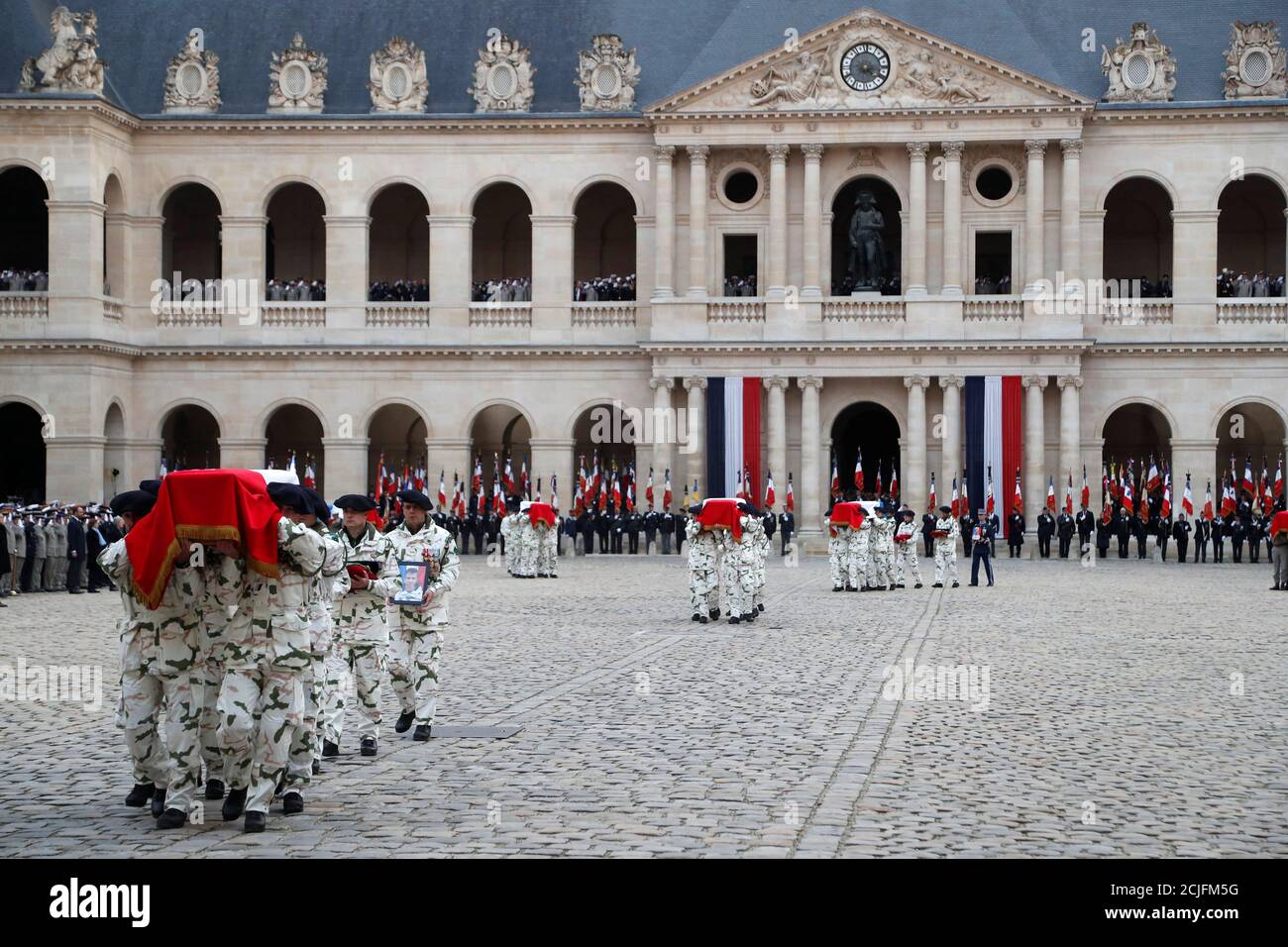 Soldiers carry away the coffin of some of the 13 French soldiers killed in Mali during a national ceremony at the Hotel National des Invalides in Paris, France, December 2, 2019. French soldiers Julien Carrette, Benjamin Gireud, Romain Salles de Saint-Paul, Clement Frison-Roche, Nicolas Megard, Romain Chomel de Jarnieu, Pierre Bockel, Alex Morisse, Jeremy Leusie, Alexandre Protin, Antoine Serre, Valentin Duval, Andrei Jouk died in Mali when their helicopters collided in the dark last week as they hunted for Islamist militants. Thibault Camus/Pool via REUTERS Stock Photo