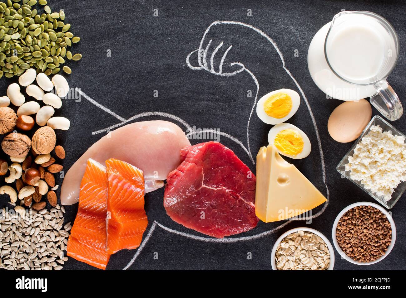 High protein food for body builders as meat, fish, dairy, eggs, buckwheat, oatmeal, nuts, bean, pumpkin seed and sunflower seed. Top view. Stock Photo