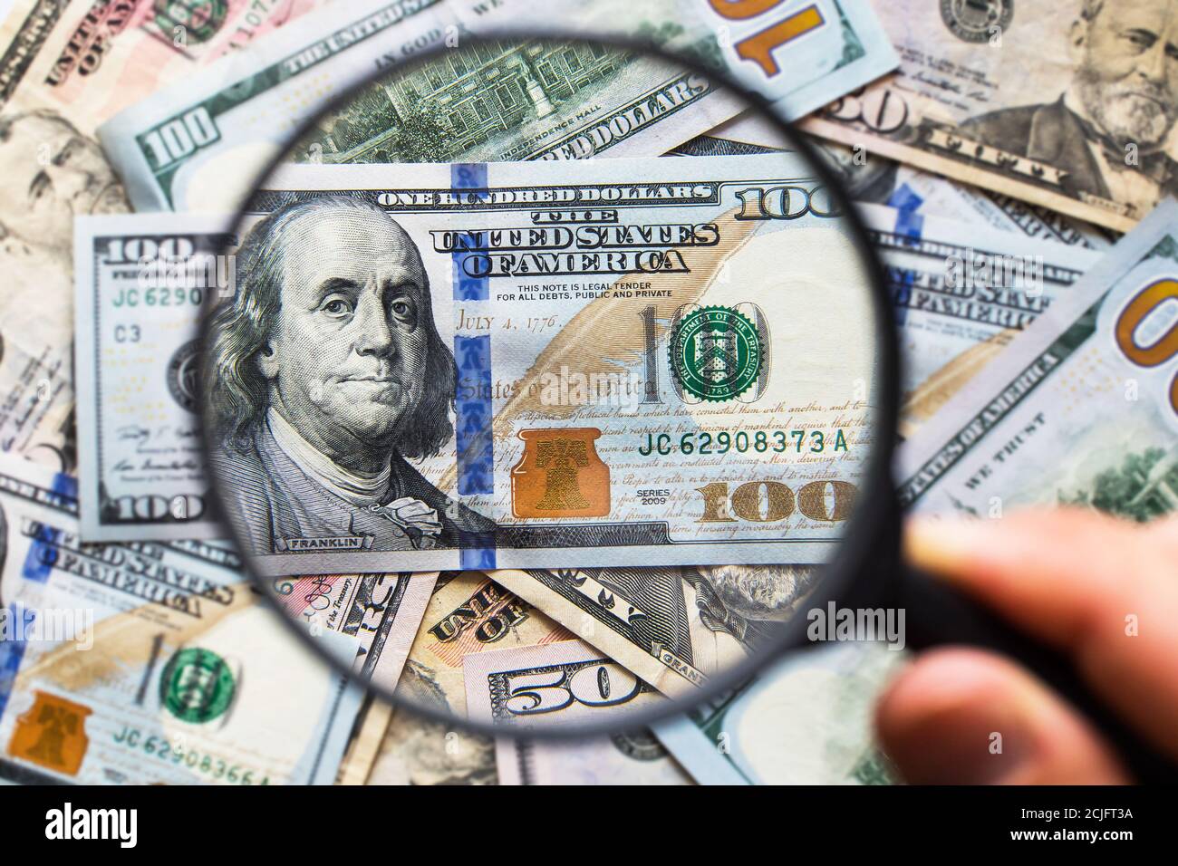 American dollars under magnifying glass. Financial analysis Stock Photo