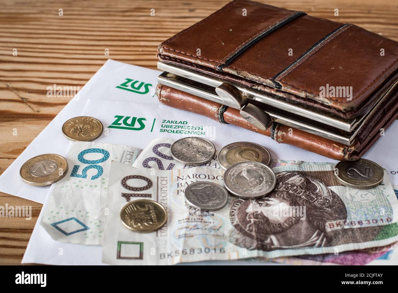 GDANSK, POLAND - 01.09.2020. Correspondence with ZUS (polish Social Insurance Institution) and old wallet with polish money. Stock Photo