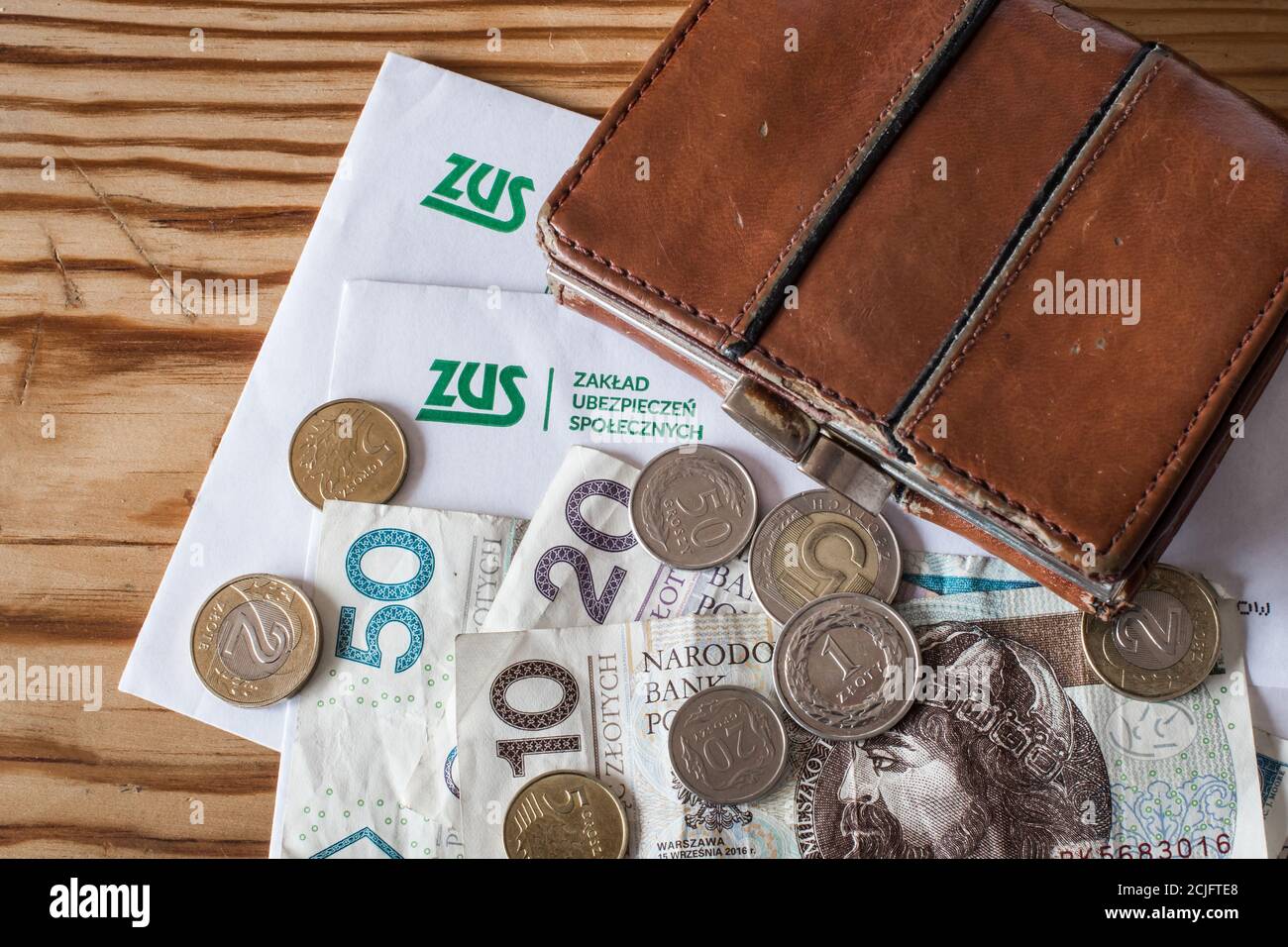 GDANSK, POLAND - 01.09.2020. Correspondence with ZUS (polish Social Insurance Institution) and old wallet with polish money. Stock Photo