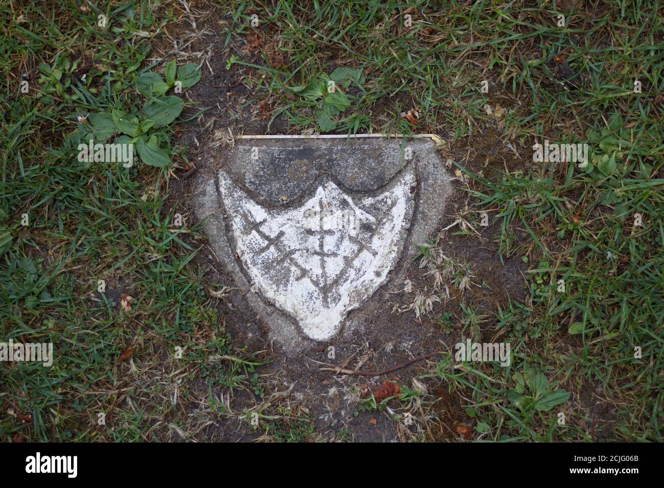 Single emblem of ducks webbed foot on plaque in grass Stock Photo