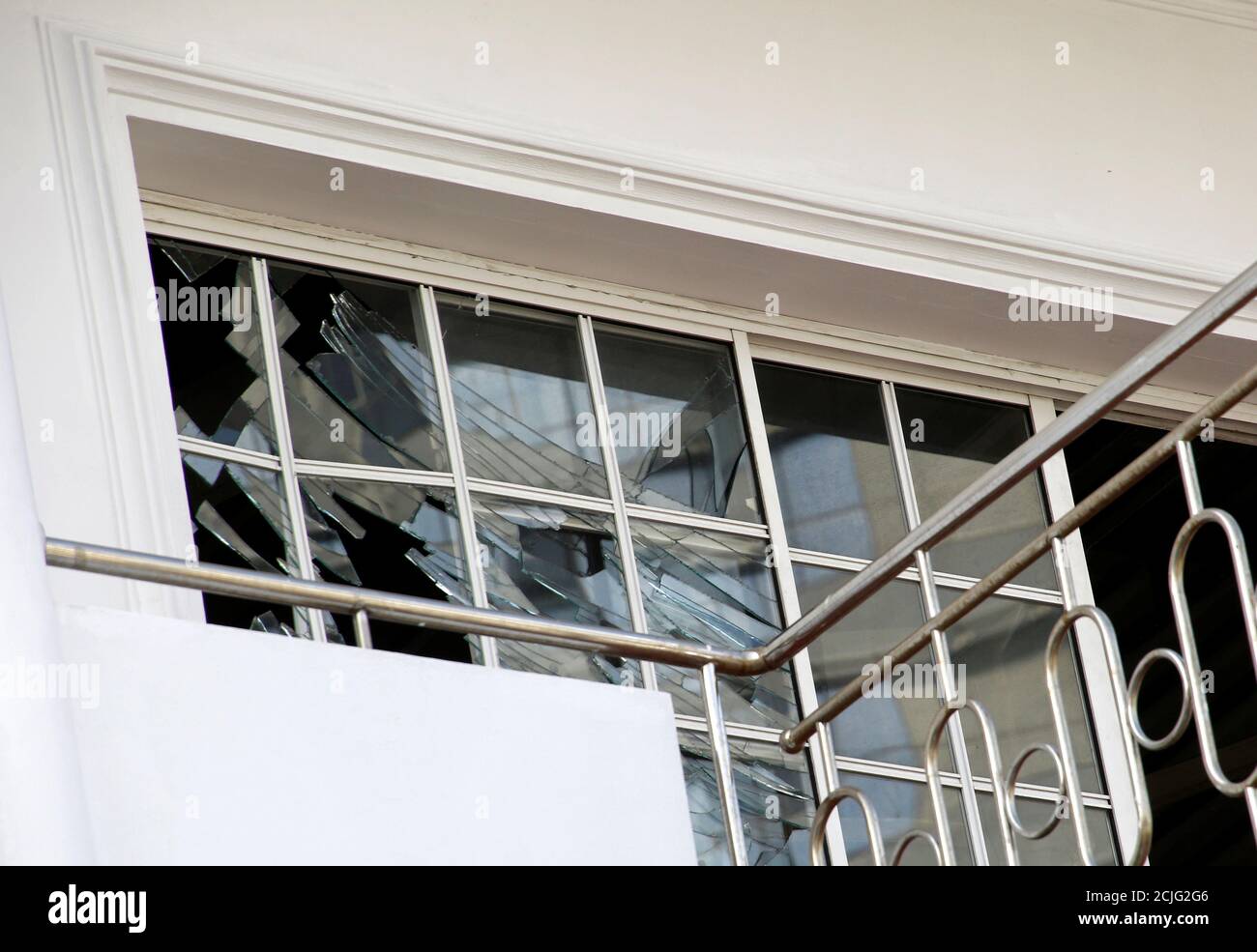 Broken windows are seen at the family home of a bomber suspect where an explosion occurred during a Special Task Force raid, following a string of suicide attacks on churches and luxury hotels, in Colombo, Sri Lanka April 25, 2019. REUTERS/Thomas Peter Stock Photo