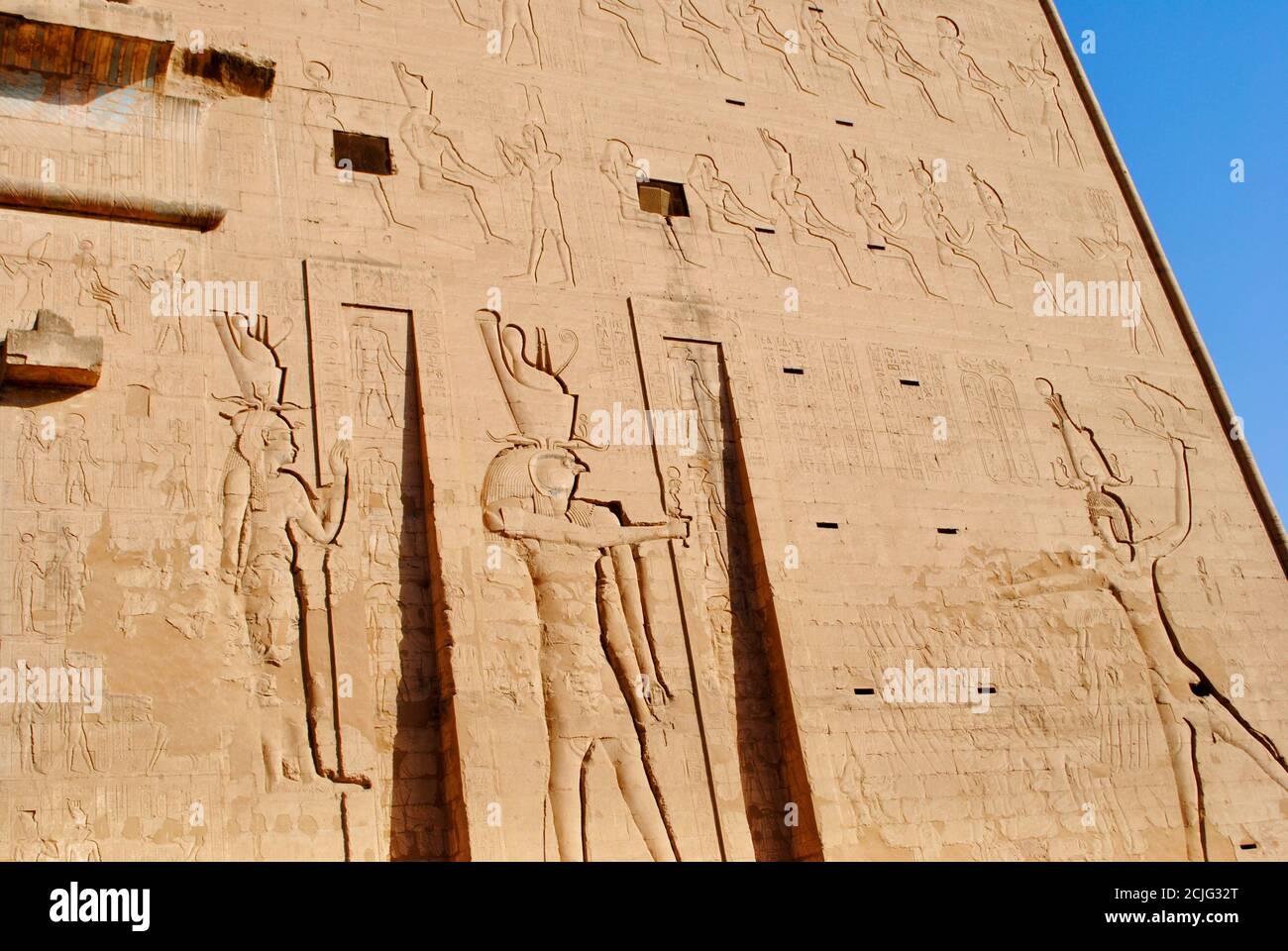 The relief of Temple of Horus, Sky God, depicted as a falcon-headed man. Edfu, West bank of the Nile, Aswan Egypt.  Stock Photo