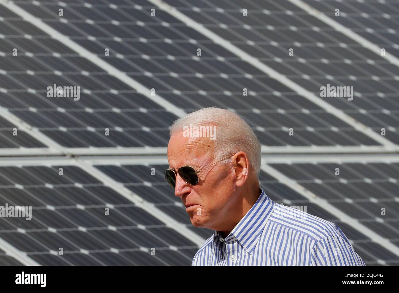 Democratic 2020 U.S. presidential candidate and former Vice President Joe Biden walks past solar panels while touring the Plymouth Area Renewable Energy Initiative in Plymouth, New Hampshire, U.S., June 4, 2019.   REUTERS/Brian Snyder Stock Photo