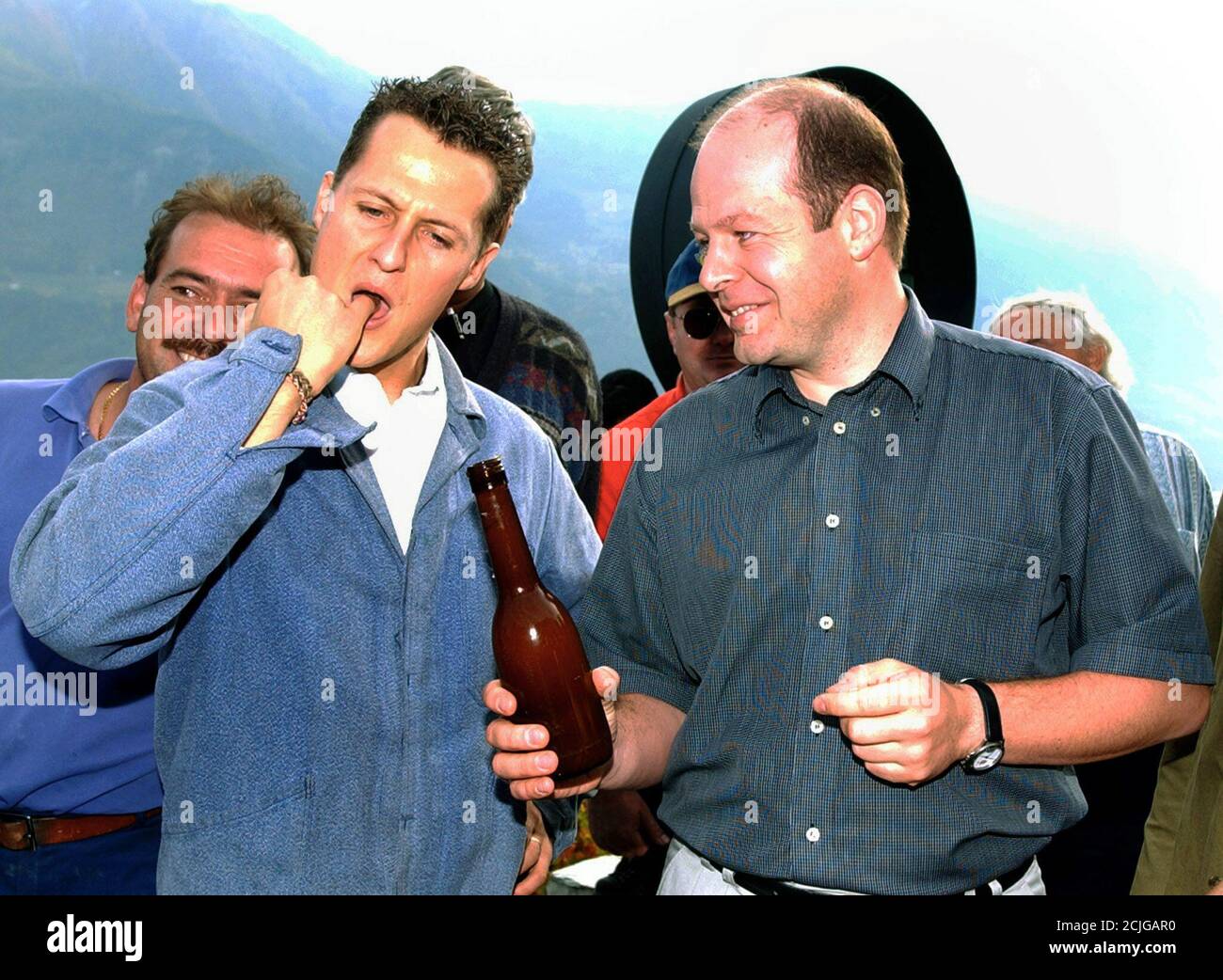 Formula One World Champion Michael Schumacher (L) tastes wine as he visits  the vineyard of Farinet in Saillon, Switzerland, October 18, 2001. The  small vineyard of Farinet, named after a famous Swiss