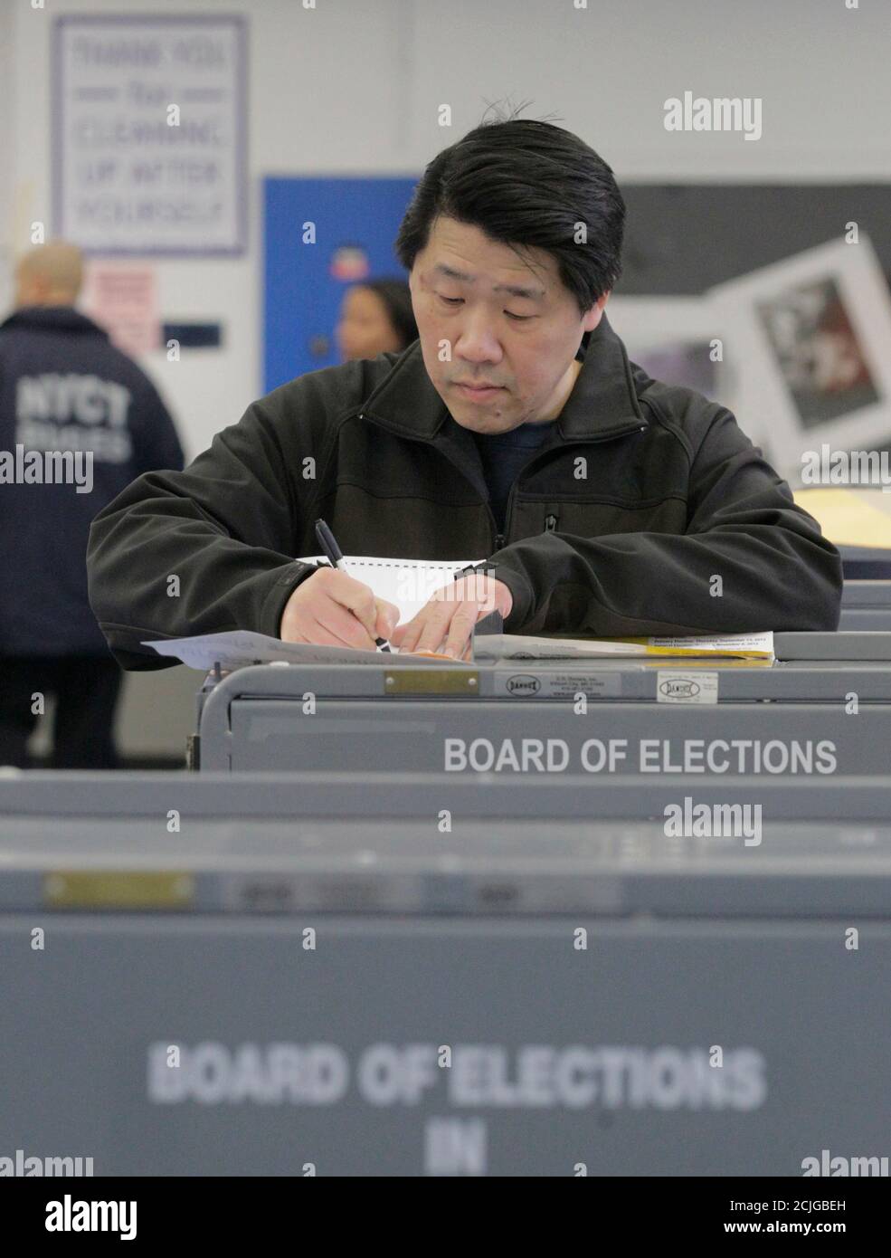 A man looks over his ballot to vote in the U.S. presidential election at a displaced polling center in the Coney Island section of Brooklyn, New York November 6, 2012.  All of the Coney Island and surrounding area polling sites were damaged during Hurricane Sandy. REUTERS/Brendan McDermid (UNITED STATES - Tags: POLITICS ELECTIONS DISASTER USA PRESIDENTIAL ELECTION) Stock Photo