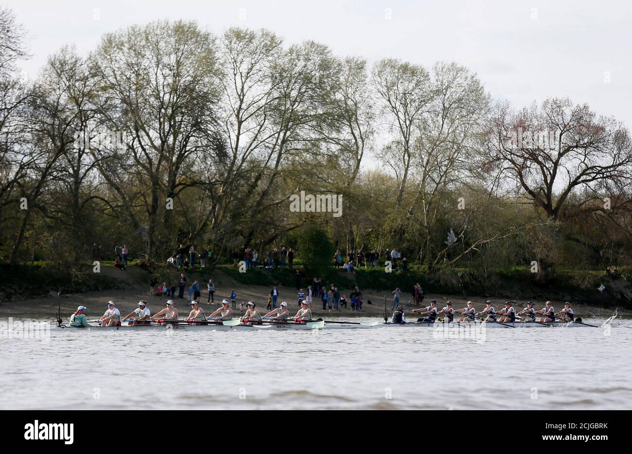 Crews from the women's Oxford (R) and Cambridge universities rowing teams row during the Boat Race on the River Thames in London, April 11, 2015.  Today, for the first time ever, the women and the men raced on the same day over the same course. REUTERS/Stefan Wermuth Stock Photo