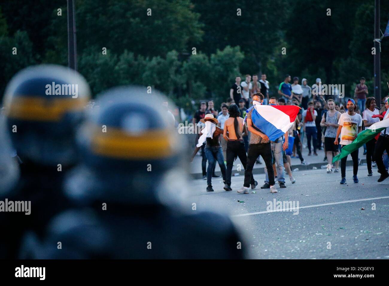 French CRS riot police hold a position during clashes near the Paris fan zone during the Portugal v France EURO 2016 final soccer match in Paris, France, July 10, 2016. French police fired tear gas to disperse dozens of people trying to enter the 'fan zone' at the foot of the Eiffel Tower to watch the final of the Euro 2016 soccer tournament on Sunday evening, to prevent overcrowding.      REUTERS/Stephane Mahe Stock Photo
