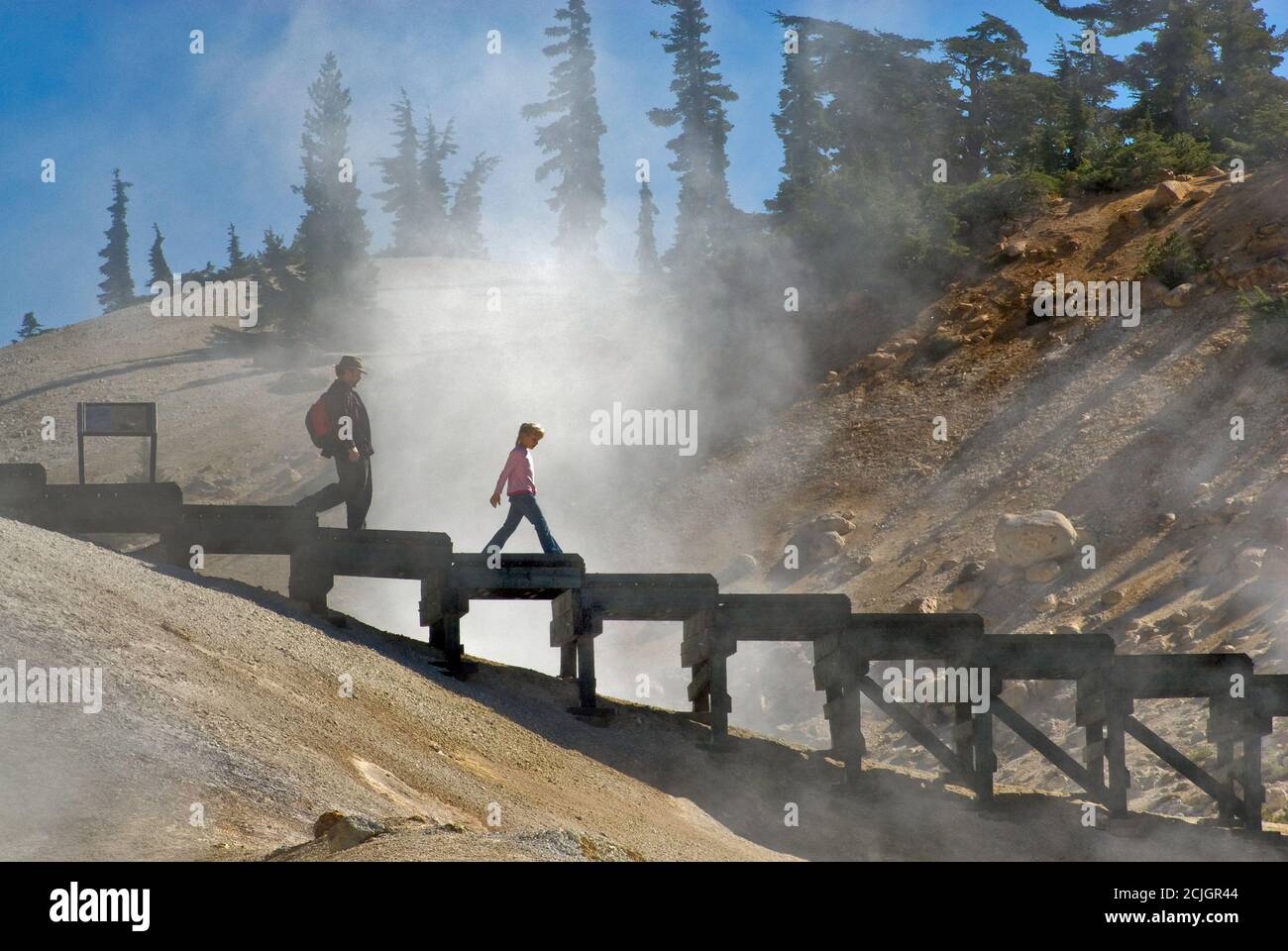 Tourists on boardwalk over fumaroles in Bumpass Hell area at Lassen Volcanic National Park, California, USA Stock Photo