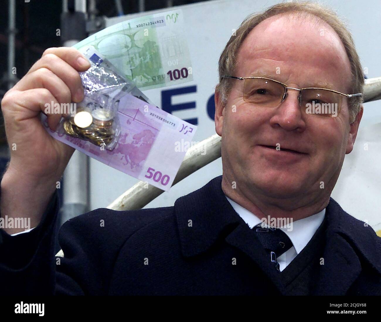 German Bundesbank President Ernst Welteke holds a so called "starter kit"  containing all eight denominations of newly minted Euro coins and a 100 and  500 Euro note during a presentation in Cologne,