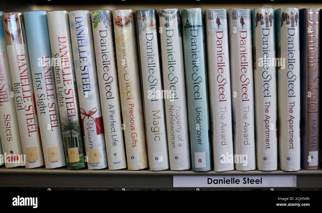 Books by author Danielle Steel are seen on a shelf inside Widnes Library in Widnes, Britain September 12, 2018. REUTERS/Phil Noble Stock Photo