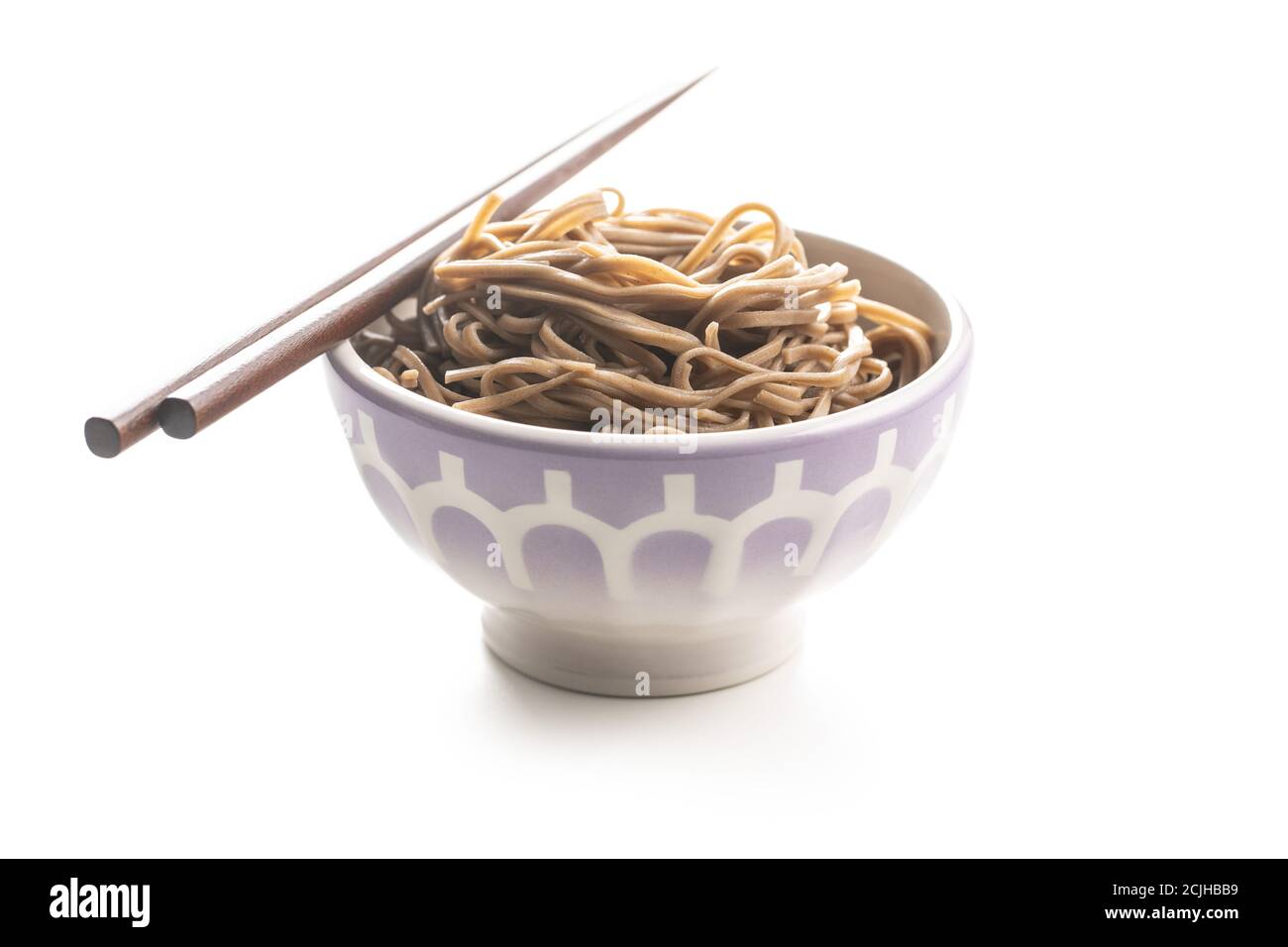 Cooked soba noodles. Traditional asian pasta in bowl isolated on white background. Stock Photo