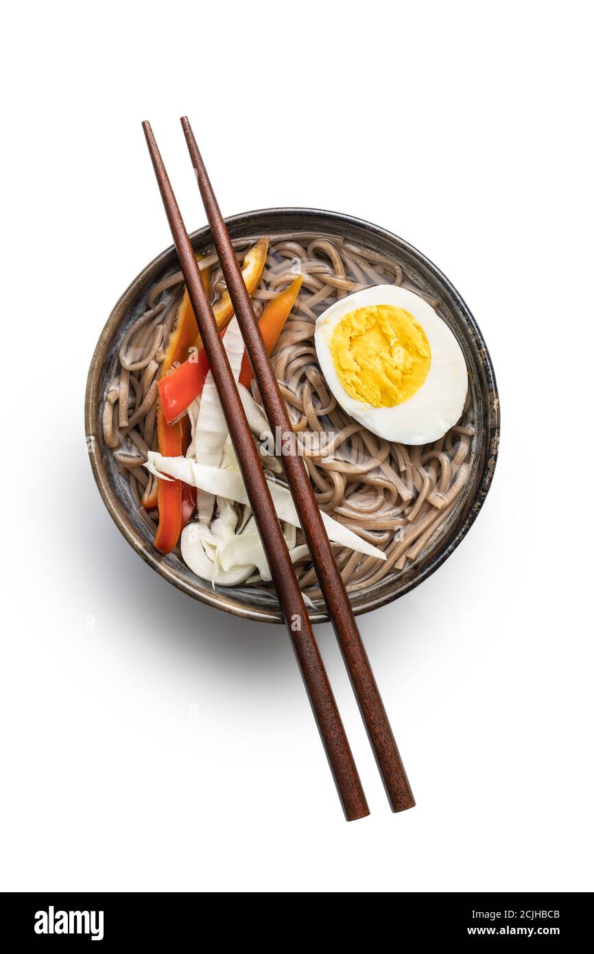 Asian noodle soup with soba noodles, vegetable and egg in bowl isolated