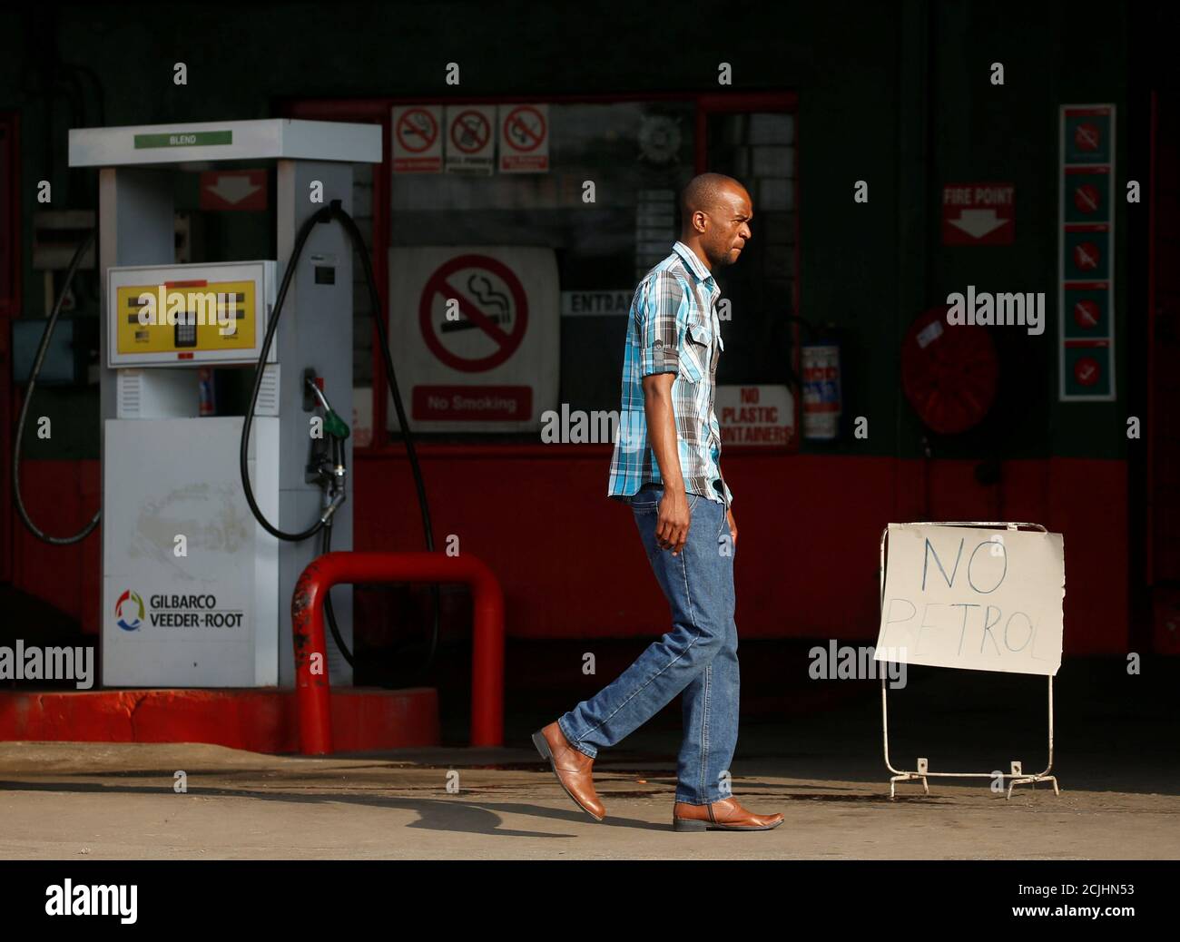 A man walks past a 'No Petrol' sign at a fuel station in Harare, Zimbabwe, November 22, 2018. REUTERS/Philimon Bulawayo Stock Photo