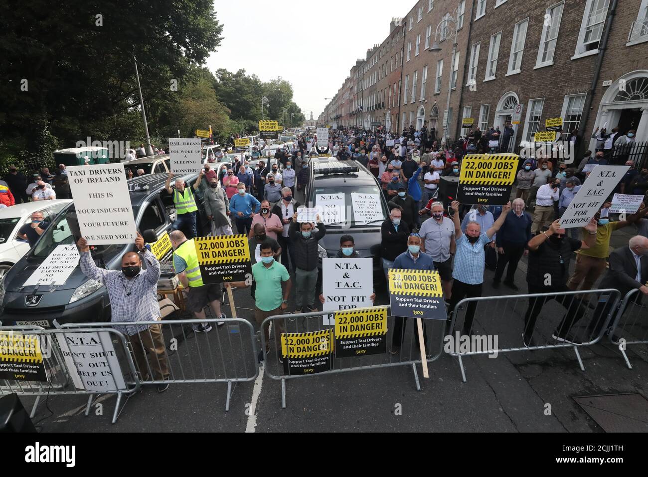 Taxi drivers at a barricade take part in a protest in Merrion Square, Dublin, calling for greater support from the National Taxi Association (NTA) during the coronavirus pandemic which has left businesses hit hard. Stock Photo