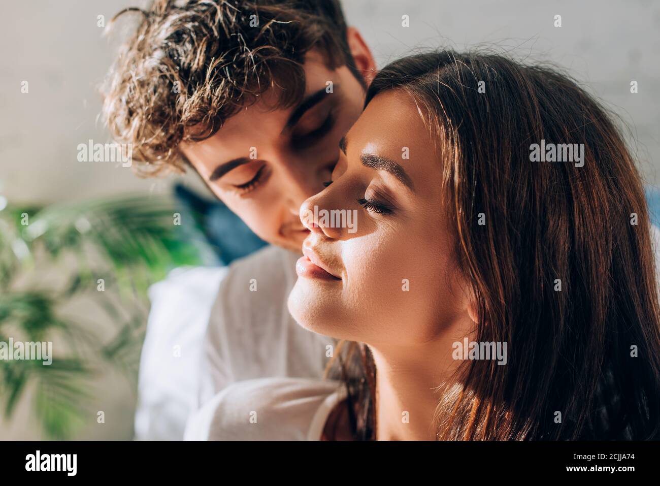 Selective focus of joyful couple with closed eyes Stock Photo