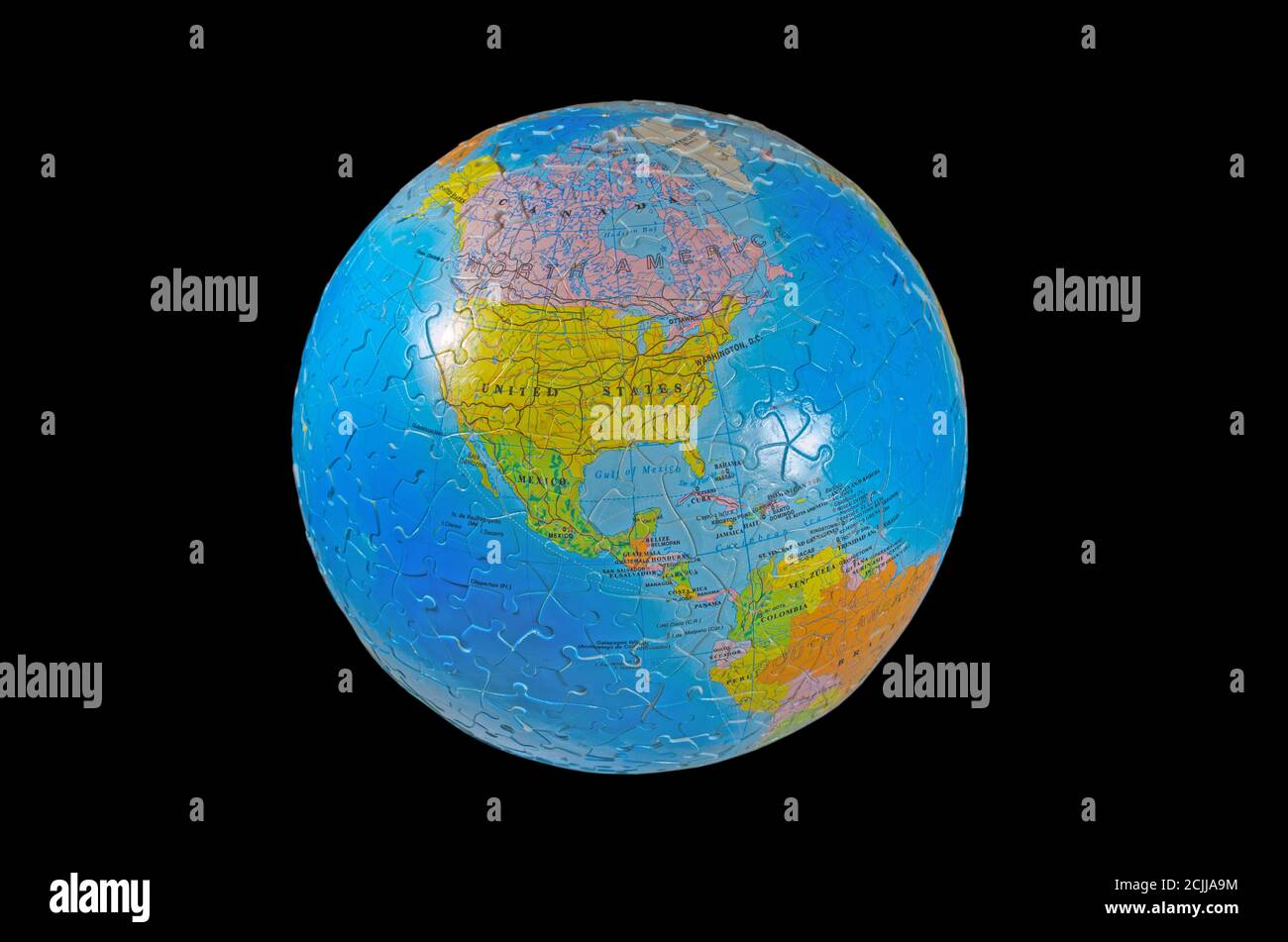 World globe seeing United States in the middle (a three-dimensional earth map 3D puzzle, isolated in black background) Stock Photo