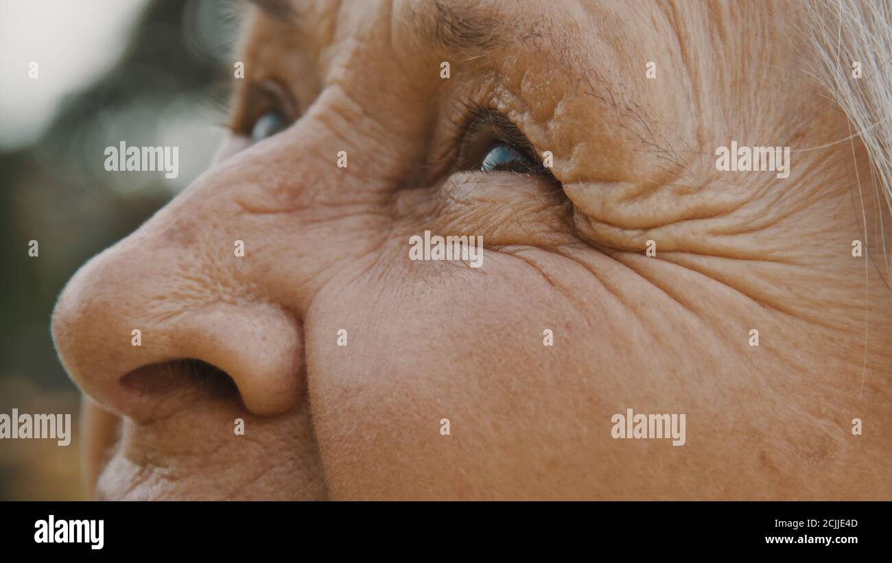 Close up, eyes of old woman in the park. looking up in the sky. High quality photo Stock Photo