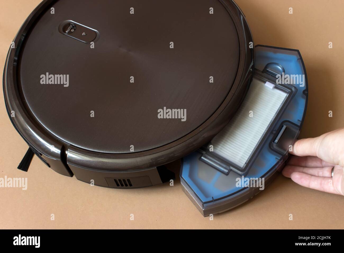 Robotic vacuum cleaner. Container with garbage from a smart robot vacuum cleaner. housework and technology concept Stock Photo
