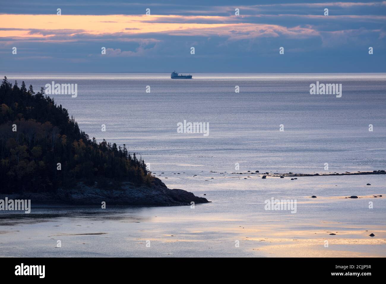 A ship (tanker) in the St Lawrence Estuary at dawn from Tadoussac, Quebec, Canada Stock Photo