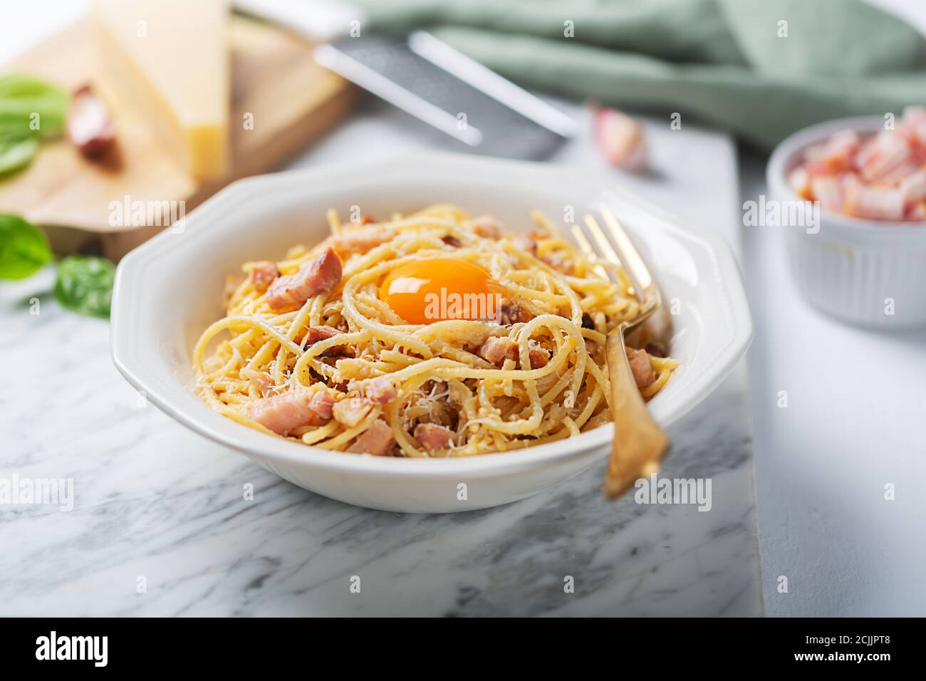 Italian pasta carbonara made with egg, hard cheese, cured pork