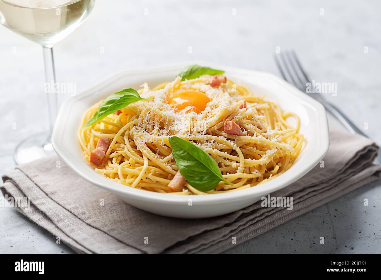 Italian pasta carbonara made with egg, hard cheese, cured pork