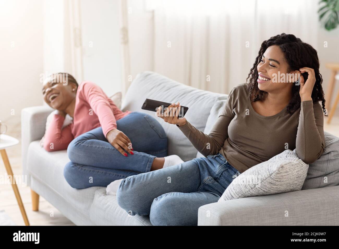 Two beautiful girls on couch hi-res stock photography and images - Alamy