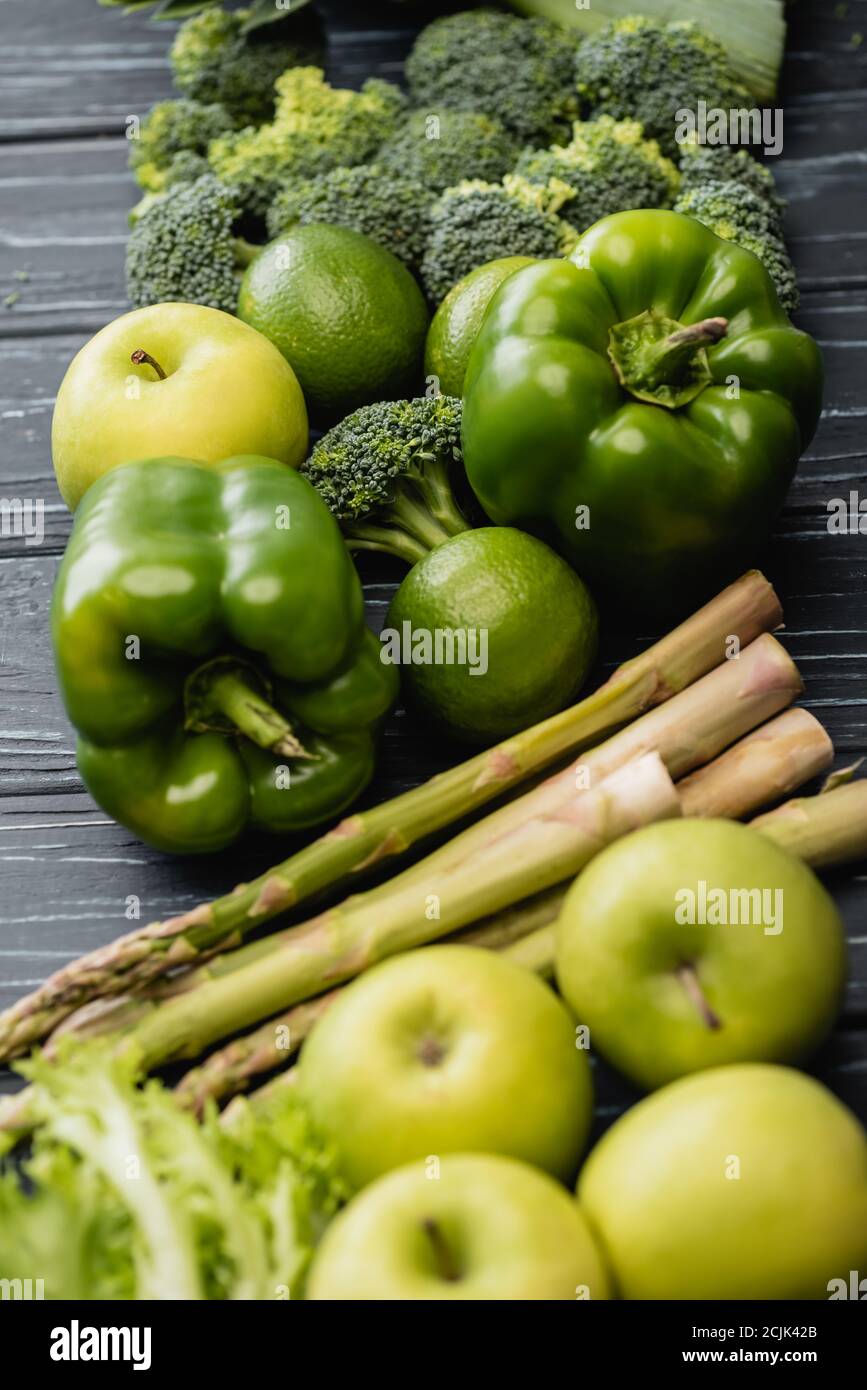 selective focus of fresh green ripe fruits and vegetables on wooden ...