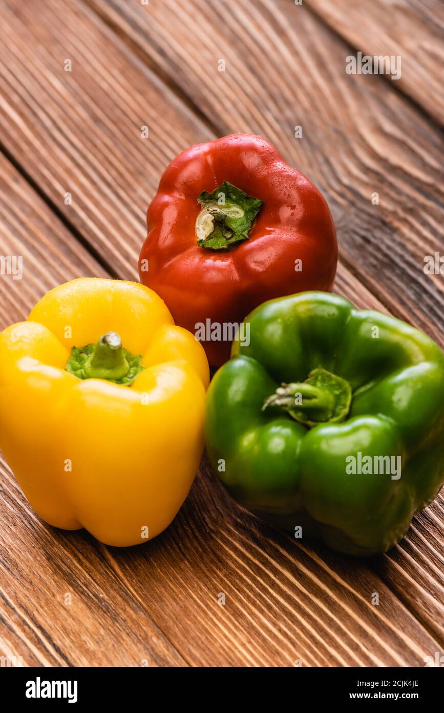 colorful ripe bell peppers on wooden table Stock Photo - Alamy