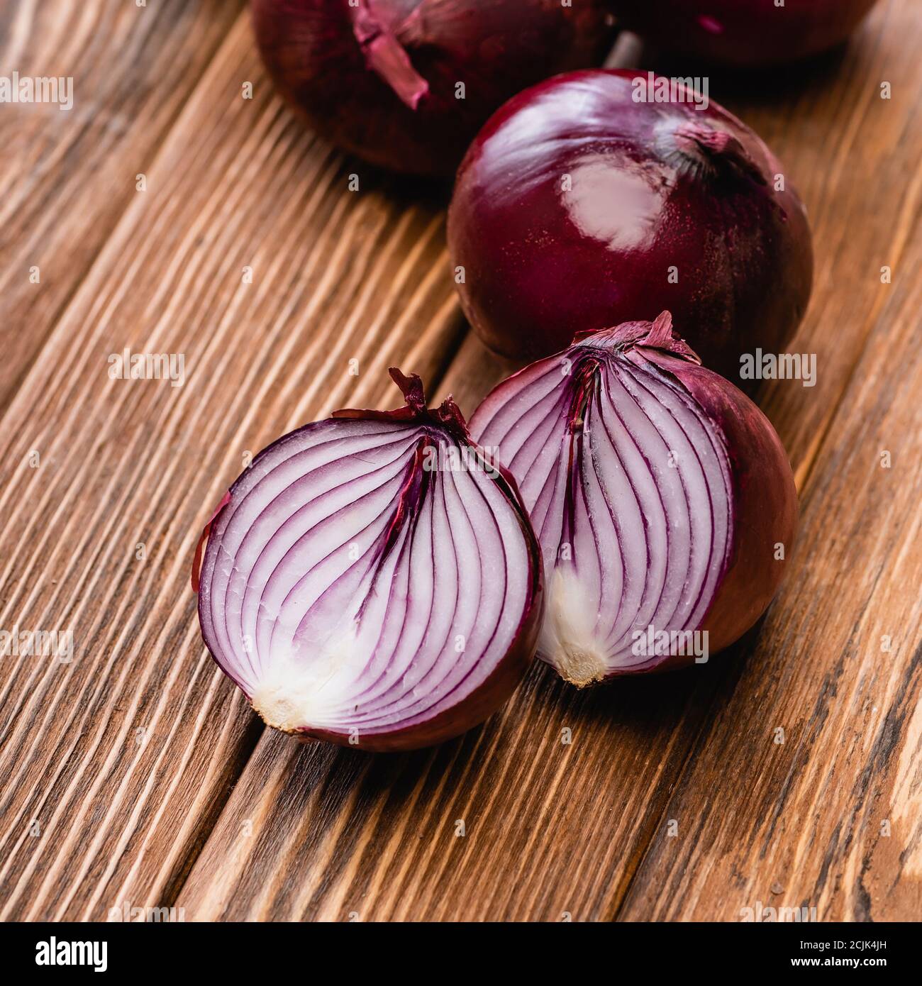 close up view of red onion halves on wooden table Stock Photo - Alamy