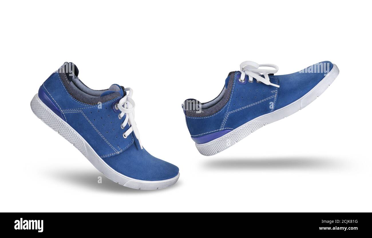 Stylish casual blue suede shoes walking forward, isolated on white background, lifestyle concept Stock Photo