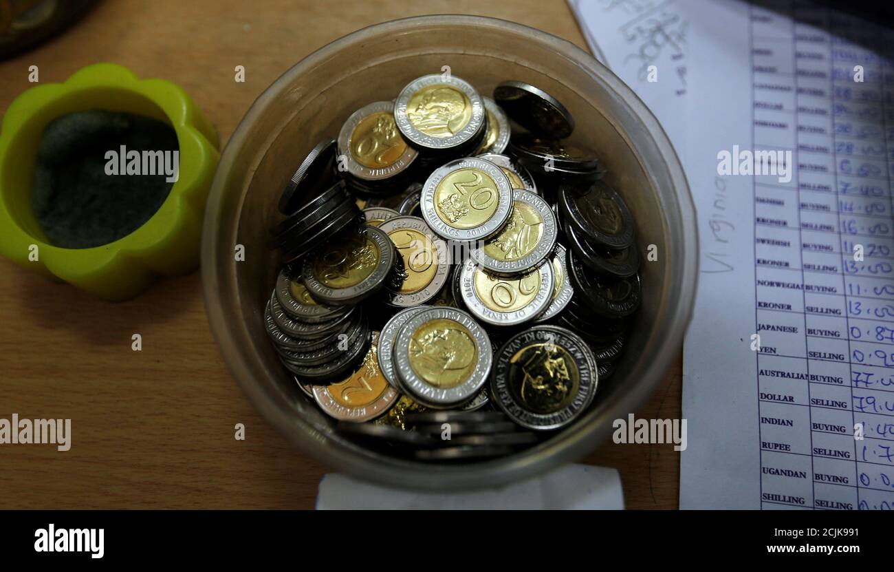 Kenya 20 shillings coins are seen in a plastic container inside a cashier's booth at a forex exchange bureau in Kenya's capital Nairobi, April 20, 2016. REUTERS/Thomas Mukoya Stock Photo