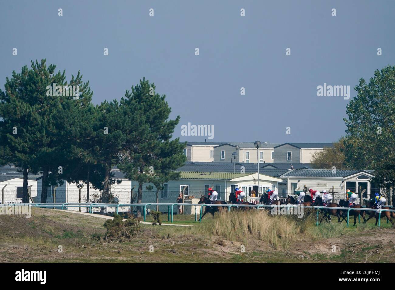 A general view as runners race down the back straight in The British EBF Premier Fillies' Handicap at Great Yarmouth Racecourse. Stock Photo