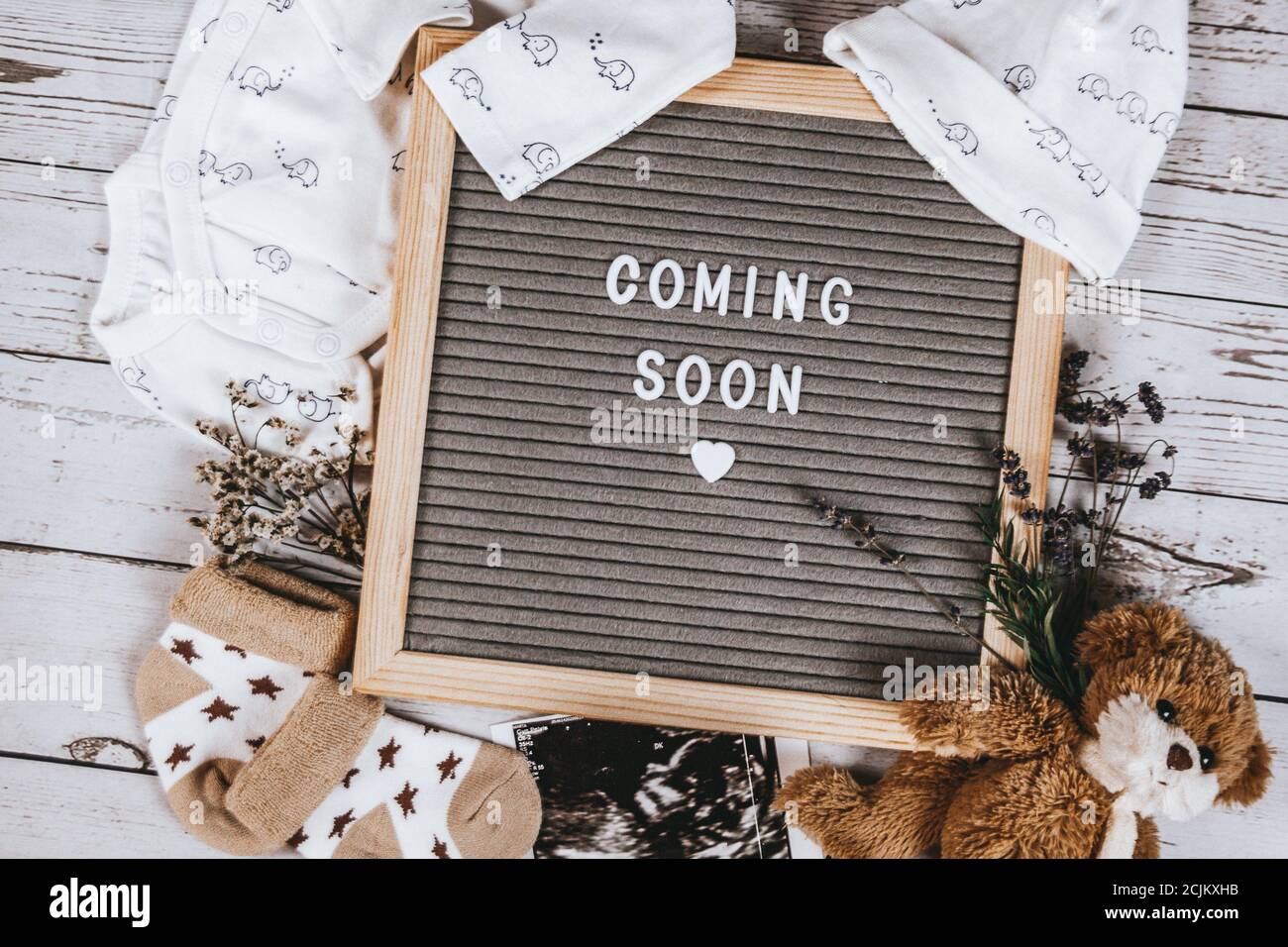 Coming soon sign. Baby announcement sign on a rustic white background. Coming soon concept. Stock Photo