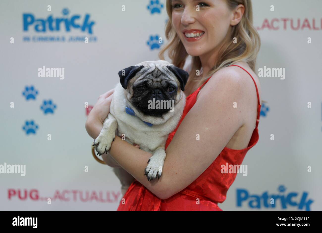 Actor Beattie Edmondson poses for photographs with her co-star, a Pug dog  called Harley, at the premiere of the film "Patrick" in London, Britain  June 27, 2018. REUTERS/Peter Nicholls Stock Photo -