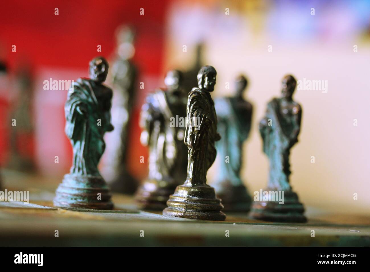 Closeup of bronze chess pieces in the Greek style, human figurines Stock Photo