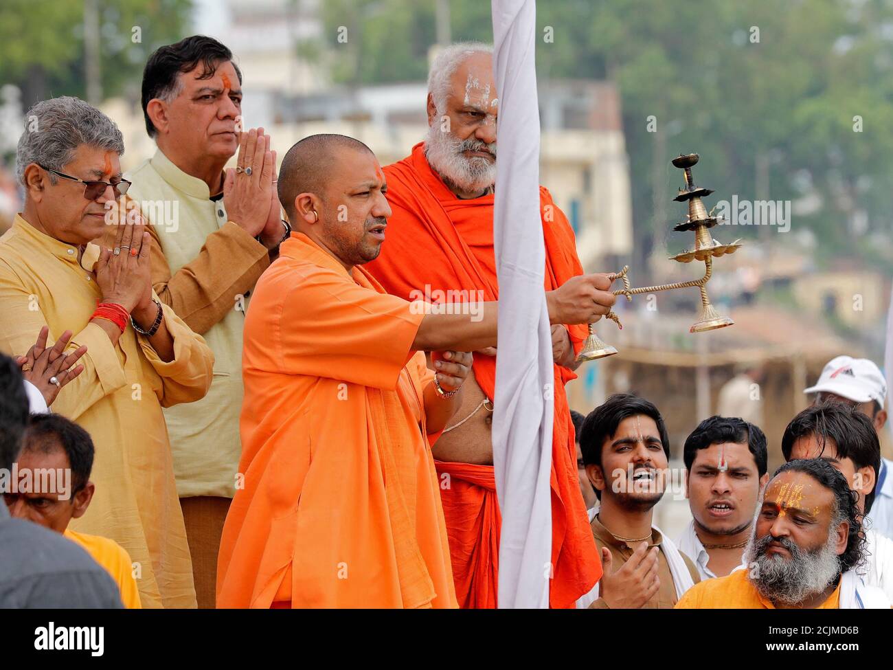 Yogi Adityanath, Chief Minister of India's most populous state of Uttar Pradesh, holds a traditional lamp as he performs prayers called Yogi Adityanath, Chief Minister of India's most populous state of Uttar Pradesh, holds a traditional lamp as he performs prayers called