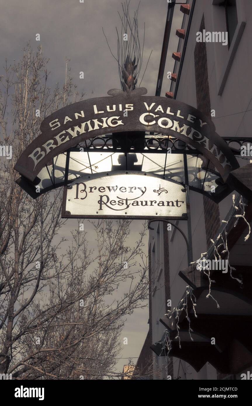 Metal sign attached to the side of a historic brick building for the San Luis Valley Brewing Company, a brewery and restaurant in Alamosa, Colorado. Stock Photo