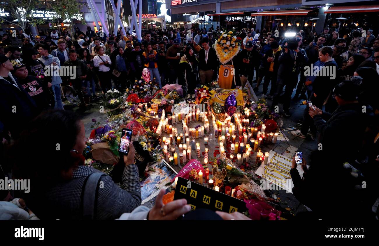 Mourners gather at a makeshift memorial for Kobe Bryant outside the Staples Center after the retired Los Angeles Lakers basketball star was killed in a helicopter crash, in Los Angeles, California, U.S., January 26, 2020. Picture taken January 26, 2020. REUTERS/Mario Anzuoni     TPX IMAGES OF THE DAY Stock Photo