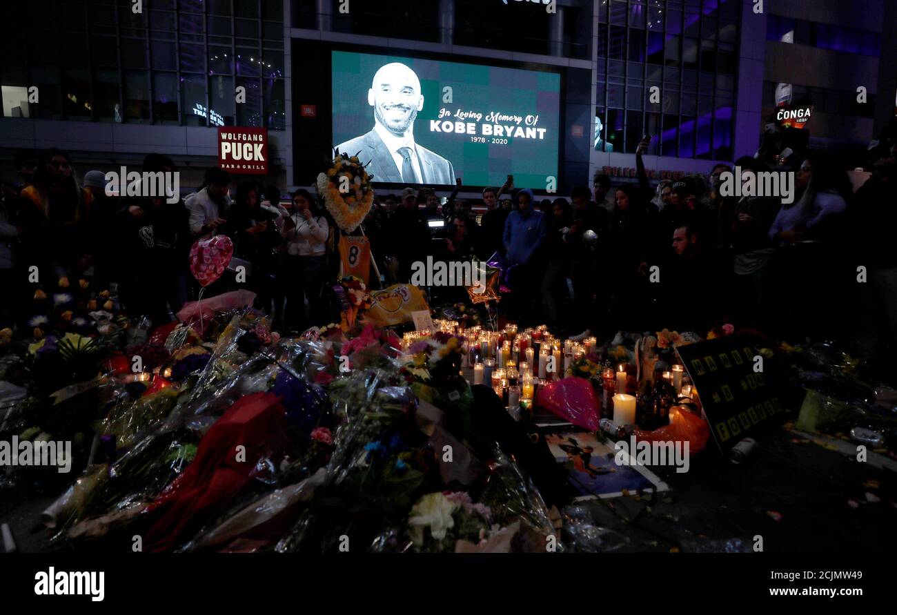 Mourners gather at a makeshift memorial for Kobe Bryant outside the Staples Center after the retired Los Angeles Lakers basketball star was killed in a helicopter crash, in Los Angeles, California, U.S., January 26, 2020. Picture taken January 26, 2020. REUTERS/Mario Anzuoni Stock Photo