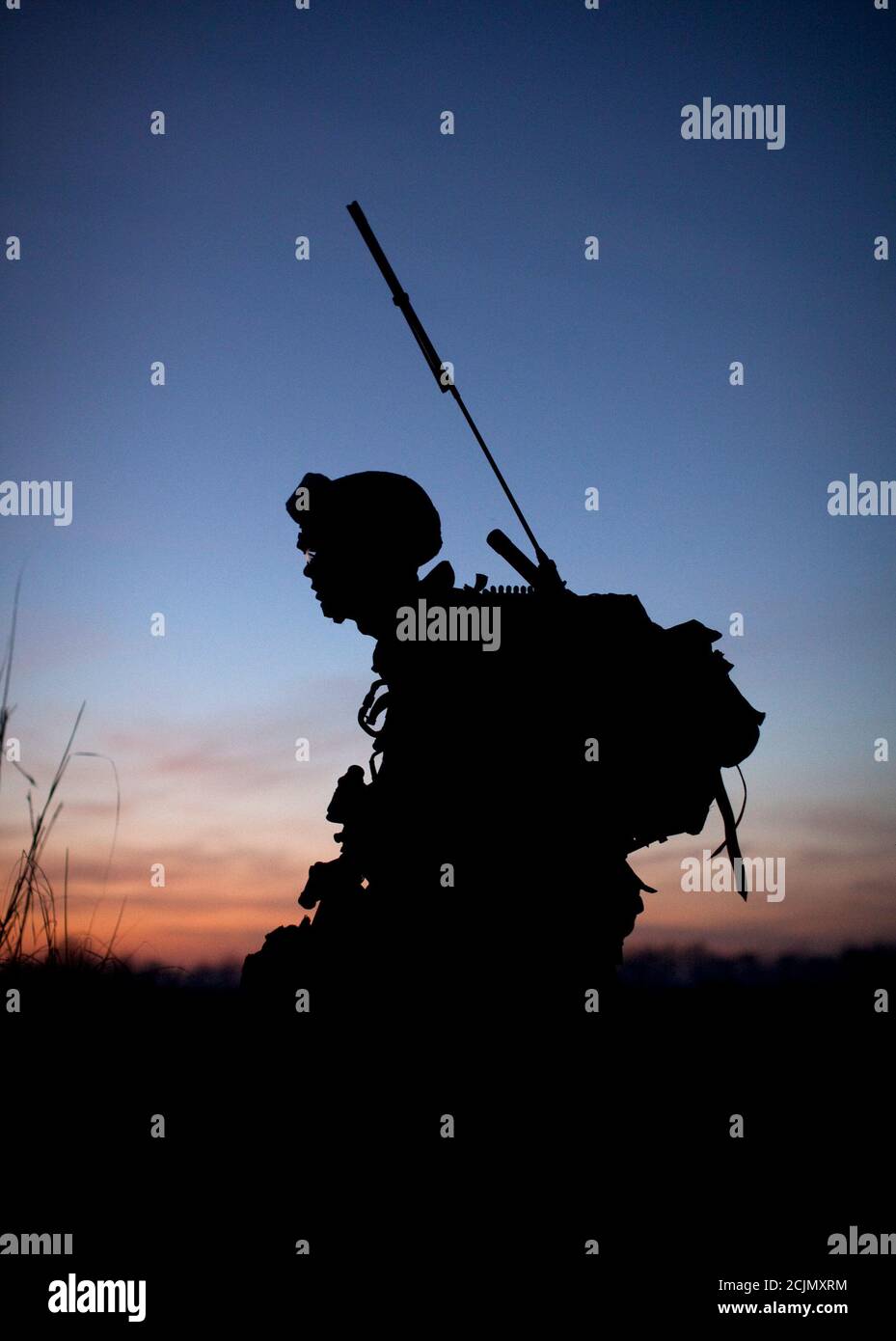 A U.S. Marine, attached to the 2nd Battalion 2nd Marines from Camp Lejeune, North Carolina, is silhouetted at dusk during an operation in Garmsir district of Helmand Province December 20, 2009.   REUTERS/Adrees Latif   (AFGHANISTAN - Tags: CONFLICT MILITARY) Stock Photo