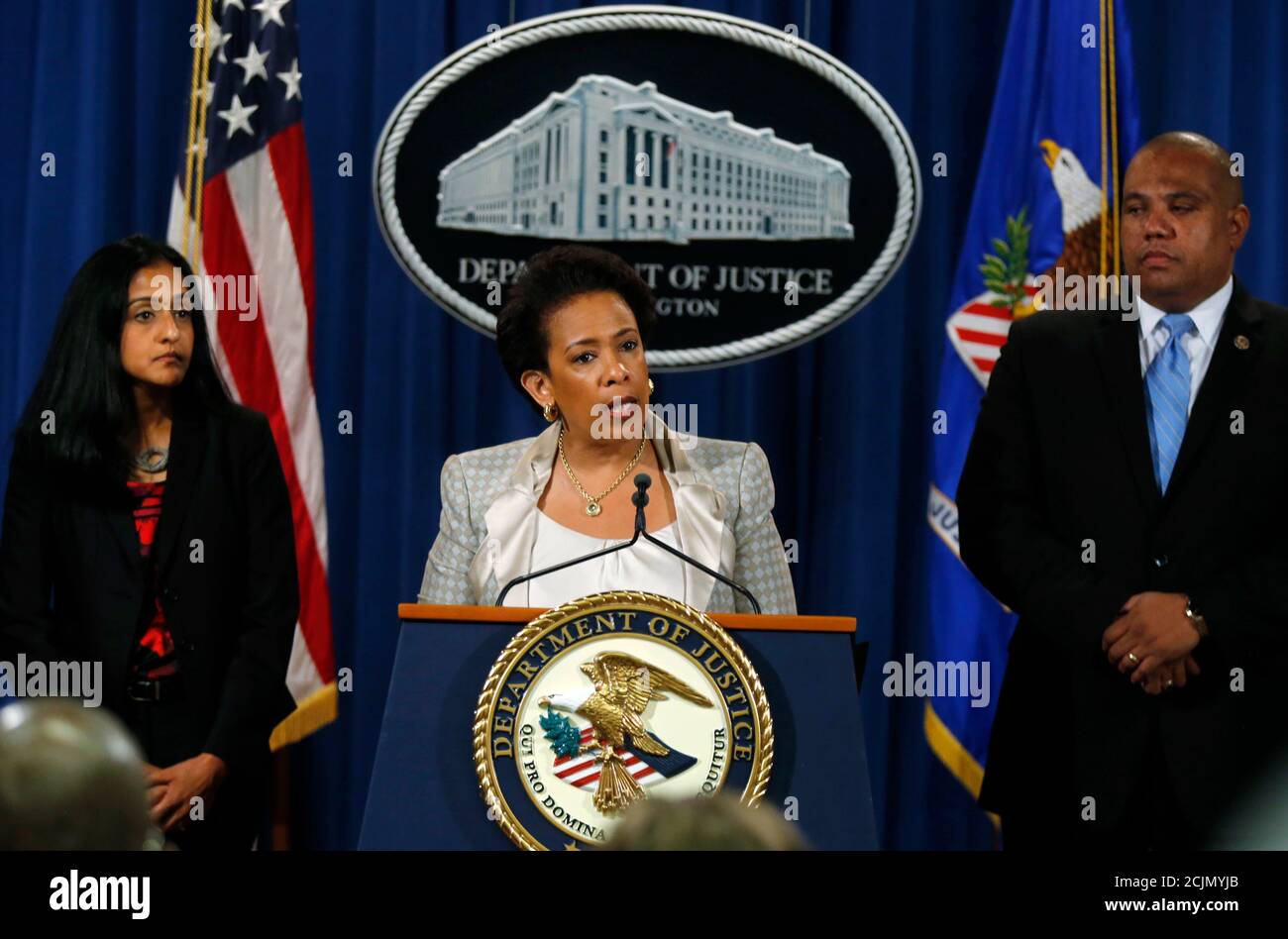 U.S. Attorney General Loretta Lynch (C) holds a news conference, where she announced a federal civil rights investigation into the legality of the Baltimore's police department's use of force and whether there are 'systemic violations' as well as any pattern of discriminatory policing, at the U.S. Justice Department in Washington May 8, 2015.Vanita Gupta (L) , head of the Civil Rights Division, and  Ron Davis, Director of the Community Oriented Policing Services (COPS) Office, look on from behind Lynch  REUTERS/Jim Bourg Stock Photo