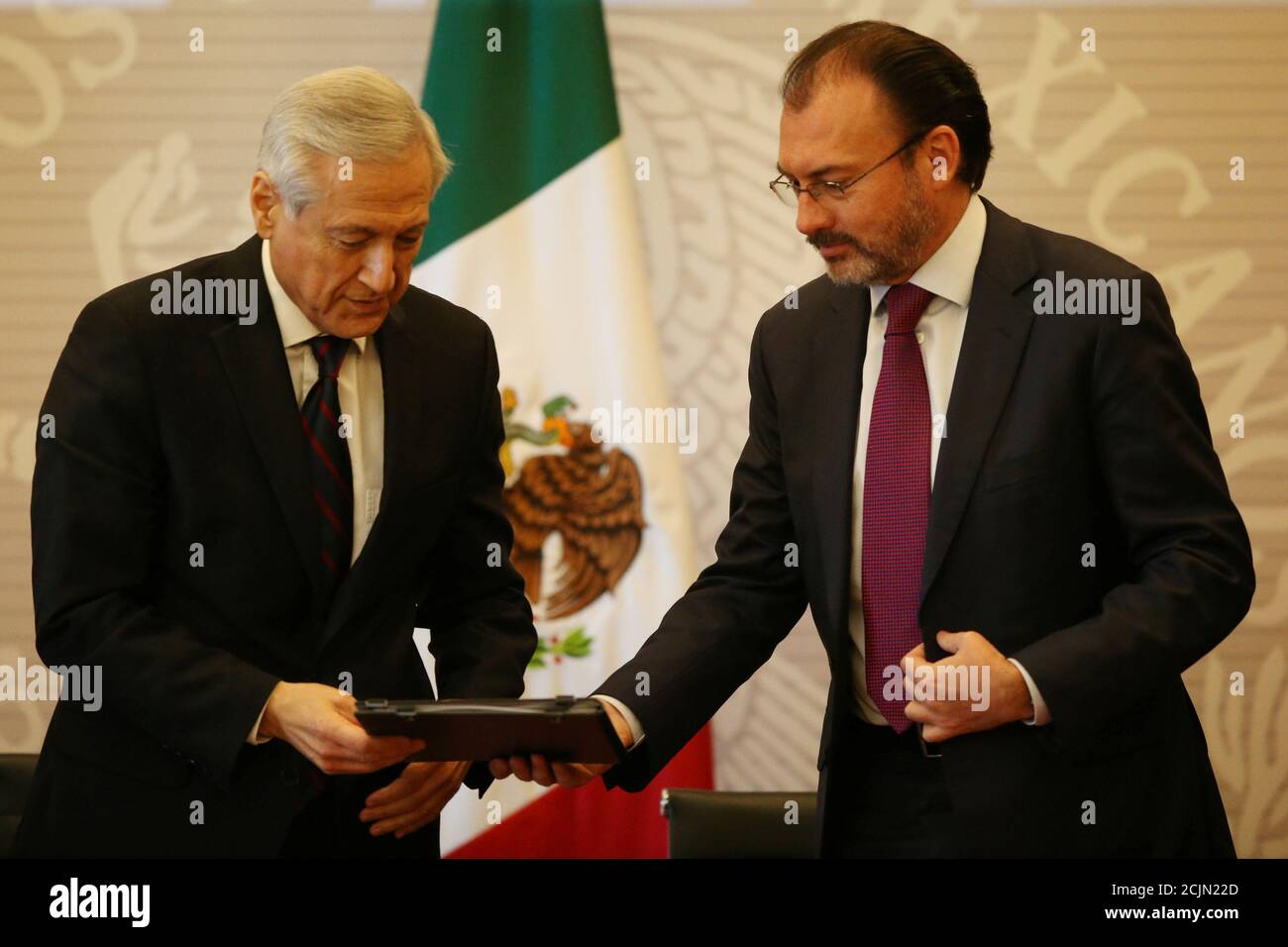 Chile's Foreign Minister Heraldo Munoz (L) gives a document to Mexico's Foreign Minister Luis Videgaray (R) during the XVII meeting of Council Ministers of the Pacific Alliance, in Mexico City, Mexico, June 2, 2017. REUTERS/Edgard Garrido Stock Photo