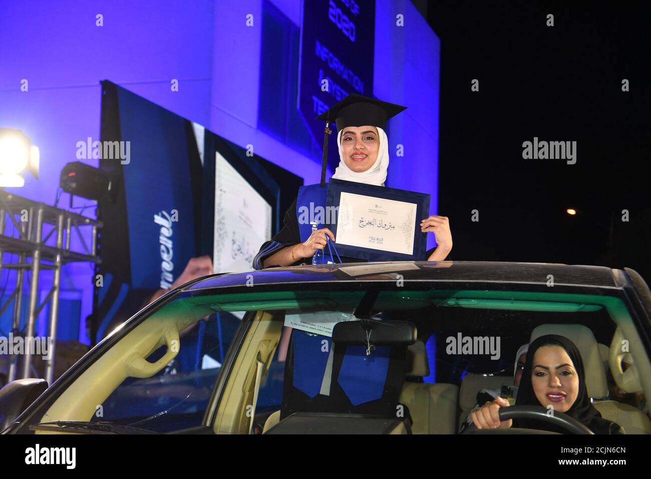 (200915) --  AHMADI GOVERNORATE, Sept. 15, 2020 (Xinhua) -- A student shows a diploma during a drive-through graduation ceremony at Kuwait Technical College (K-Tech) in Ahmadi Governorate, Kuwait, Sept. 9, 2020.  Kuwait Technical College (K-Tech) celebrated its students' graduation in the first of its kind drive-through ceremony.    More than 125 students gathered in the university's parking lot to receive their degree while driving-through to the president and keeping social distancing protocols in place.    TO GO WITH 'Feature: Kuwaiti students celebrate graduation with drive-through, virtua Stock Photo