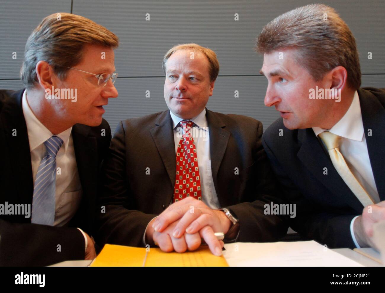 Leader of the Free Democrats Party (FDP) Guido Westerwelle (L) talks with general secretary Dirk Niebel and deputy party leader Andreas Pinkwart (R) before a FDP parliamentary group meeting in Berlin October 20, 2009.  REUTERS/Thomas Peter (GERMANY POLITICS IMAGES OF THE DAY) Stock Photo